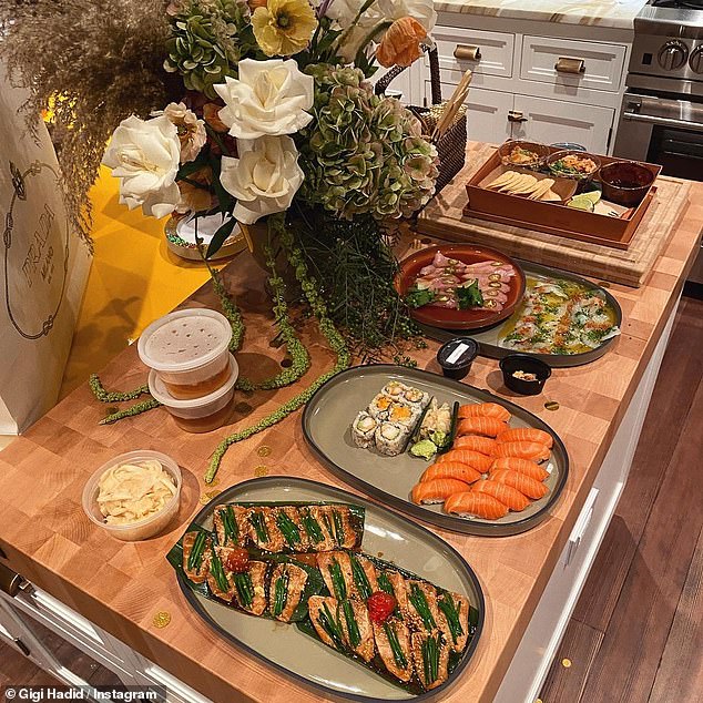Yum: The second photo in the gallery showed a delicious spread of sushi and other appetizers, along with a stunning flower bouquet and a white Prada shopping bag
