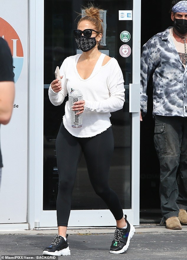 Back to the grind: Jennifer Lopez, 51, hits the gym in Miami with a shiny new souvenir after a brilliant performance at Biden's inauguration as she stuns in Chanel